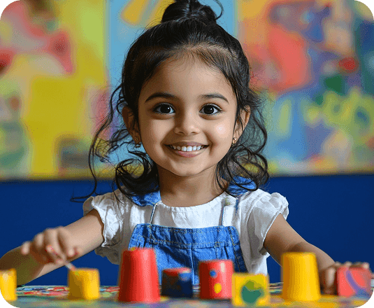 Smiling child playing with colorful blocks