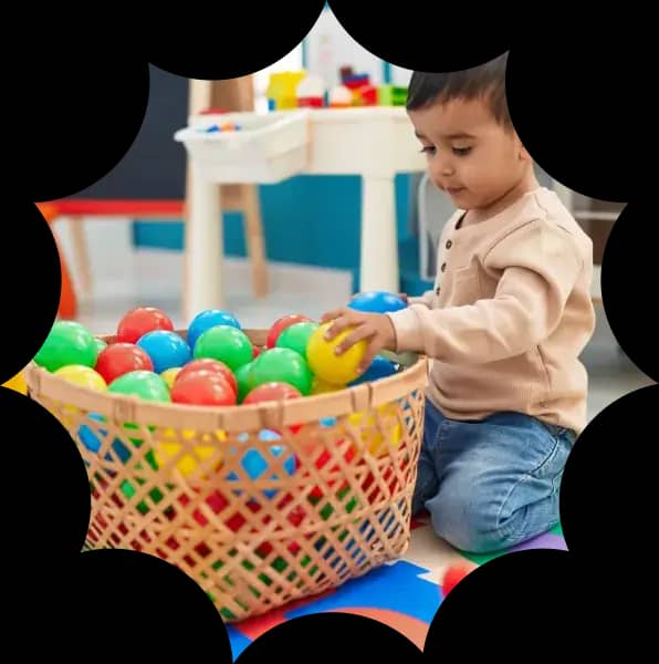 Toddler playing with colorful floor toys