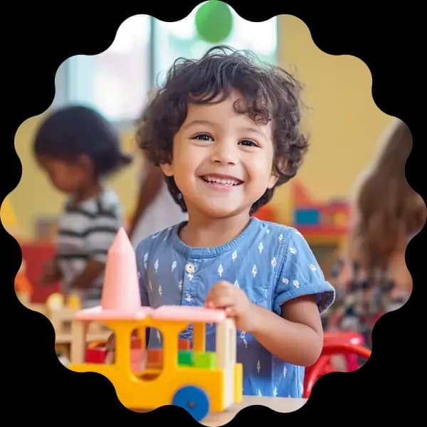 Smiling child playing with toys in the classroom
